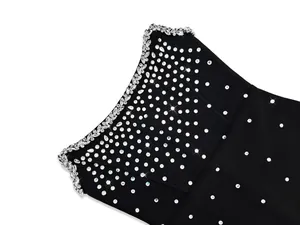 Detailed close-up of sparkling rhinestone embellishments on a black bandage party dress