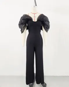 Elegant black off-the-shoulder bandage jumpsuit with sheer organza puff sleeves.