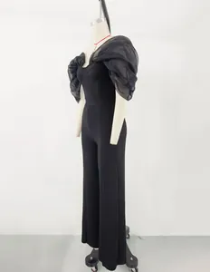 Side view of elegant black off-shoulder jumpsuit with sheer organza puff sleeves