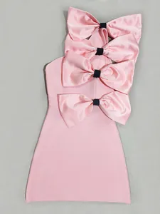 Detailed macro view of four oversized pink satin bows on a sleeveless mini dress.