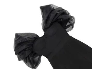 Close-up of a black off-the-shoulder bandage jumpsuit with dramatic organza puff sleeves