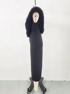 Side view of a black long bandage dress with ruffled mesh shoulder detail on a mannequin