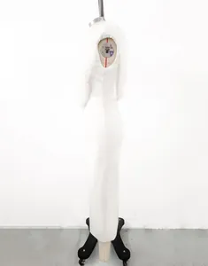 Side view of a white bandage evening dress with floral mesh detailing on a mannequin.