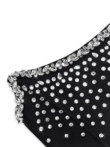 Close-up of black bandage dress featuring sparkling rhinestones and crystal edge details