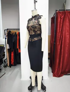 Detail view of a black lace bandage bodycon dress displayed on a mannequin in a studio.