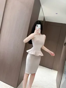 Elegant beige two-piece knit set featuring a peplum top and a bandage bodycon midi skirt