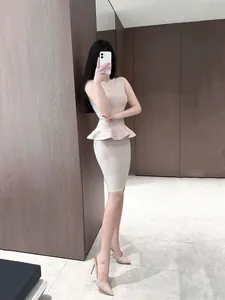 Elegant beige two-piece set with peplum top and slim-fit bandage skirt for office wear