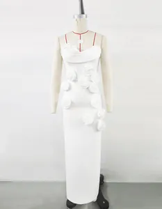 Detail view of a white French-style floor-length dress with elegant 3D floral accents.