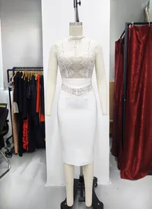 Full front view of elegant white lace bandage bodycon dress displayed on a studio mannequin
