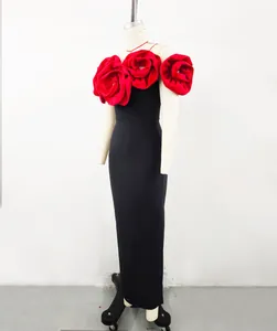 Detailed view of the elegant black bandage dress with large red floral decorations