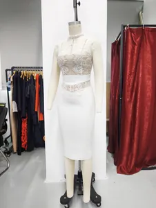 White mock neck lace bandage bodycon dress displayed on a mannequin