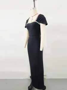 Detail view of black French bandage evening gown with rhinestone neckline on mannequin