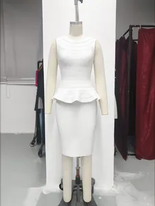 Detail of white bandage two-piece set featuring a peplum top and slim bodycon skirt