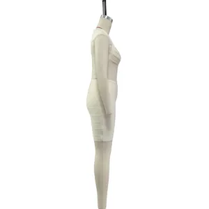 Side view profile of an elegant cream long sleeve bandage dress shown on a mannequin