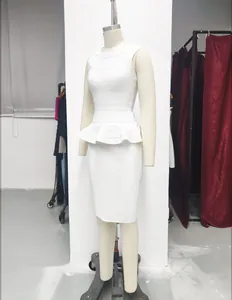 Close-up of white bandage two-piece set featuring a peplum top and pencil skirt.