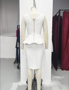 Back view of white bandage peplum top and pencil skirt with gold zipper detail.