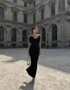 Elegant black bandage evening gown featuring luxury ostrich feather trim and fitted silhouette.