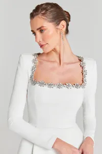 Detail of white square neck dress with elegant flower rhinestone embellishments