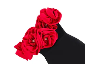 Detail view of elegant black bandage dress featuring large 3D red fabric roses decorations