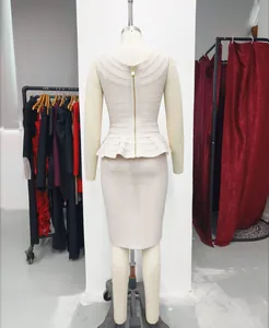 Back view detail of beige knit two-piece set with ruffled peplum and slim bandage skirt.