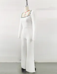 Side view of white long-sleeve flare jumpsuit with rhinestone square neckline