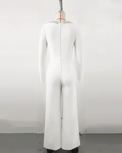 Back view of elegant white long-sleeve jumpsuit with rhinestone neckline and bell-bottom legs