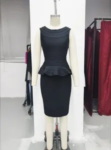 Detailed view of sophisticated black peplum knit top and bandage pencil skirt set on mannequin