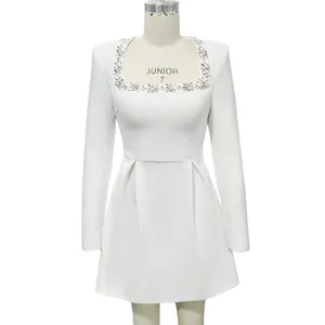 Detailed view of white French square neck dress with elegant rhinestone embellishment