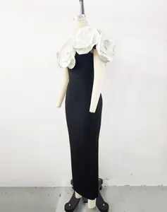 Detail of black bandage evening gown featuring elegant 3D white flower appliqués on shoulders