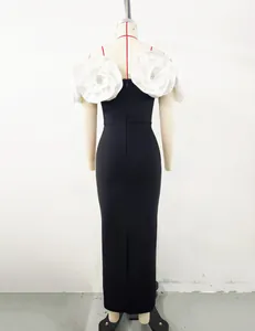 Back view of elegant black bandage dress featuring large white 3D floral shoulder details
