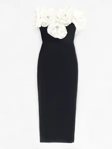 Detailed view of an elegant black bandage dress with 3D white floral embellishments