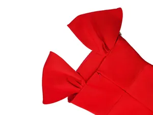 Detail view of a red French bandage evening gown featuring elegant back bow straps and rhinestones
