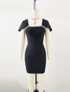 Elegant black bandage dress featuring a sparkling rhinestone neckline on a mannequin