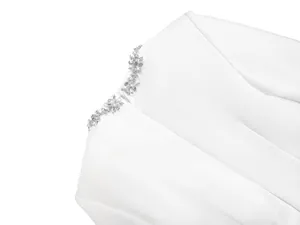 Macro view of exquisite sparkly rhinestone flower details on a premium white bandage dress
