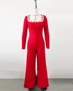 Elegant red long-sleeved jumpsuit featuring a rhinestone square neck and flared leg design