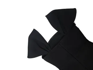 Detailed view of black bandage evening dress with hidden zipper and shoulder fold