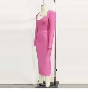 Side view detail of a pink long-sleeved bandage dress with structured ox horn shoulders