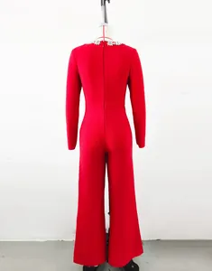 Back view of elegant red long-sleeve flare jumpsuit featuring rhinestone neckline