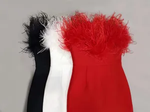 Close-up of elegant bandage dresses with ostrich feather trim in three colors