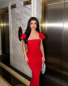 Detail view of the red bandage dress with rhinestone trim and delicate flutter sleeves