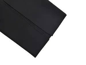 High-quality close-up of thick black ribbed bandage dress fabric with clean hem detail