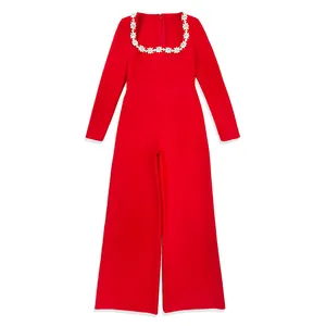 Detail view of red long sleeve jumpsuit with rhinestone flower square neckline