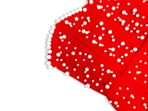 Detailed view of red high-end bandage evening dress featuring ornate white pearl accents