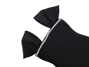 Close-up detail of a elegant black bandage dress featuring sparkling rhinestone trim.
