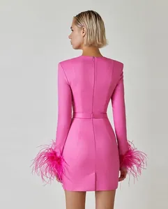 Back view of a pink bandage dress featuring elegant ostrich feather cuffs and back zipper.