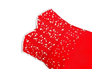 Macro detail view of a high-end red bandage dress with elegant white pearl bead decorations