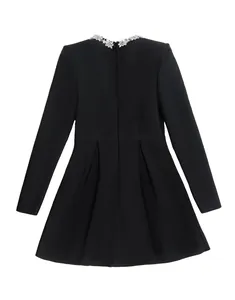 Detailed view of elegant black long-sleeved dress with exquisite rhinestone collar