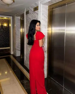 Elegant red bandage evening gown with open back shown in a luxury setting