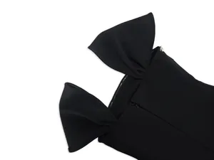 Close-up detail of a black elegant bandage evening dress featuring oversized bow shoulder straps