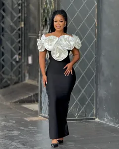Elegant black off-shoulder maxi bandage dress with large white 3D flower decorations.